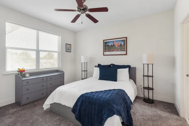 a bedroom with a bed and a window