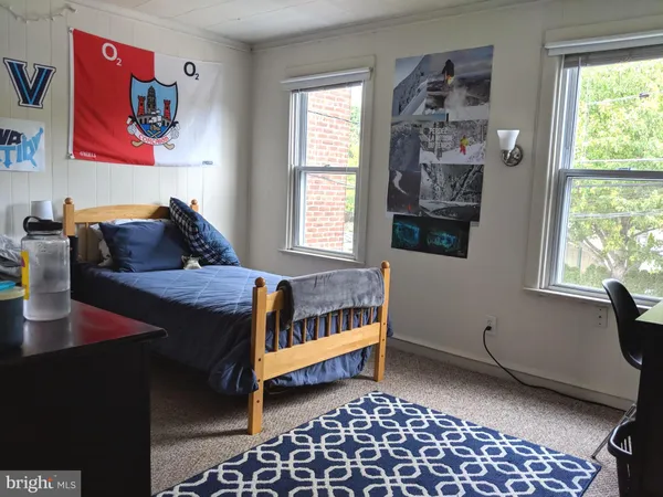 a bedroom with furniture and a window
