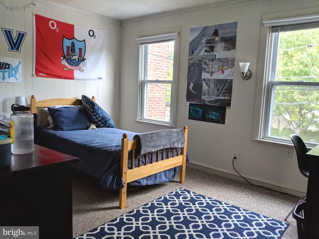 a bedroom with furniture and a window