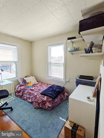 a bedroom with a bed and windows