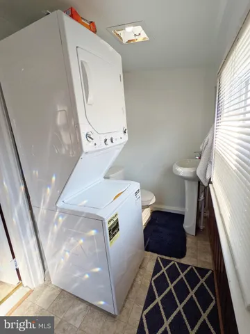 a view of a livingroom with wooden floor and windows