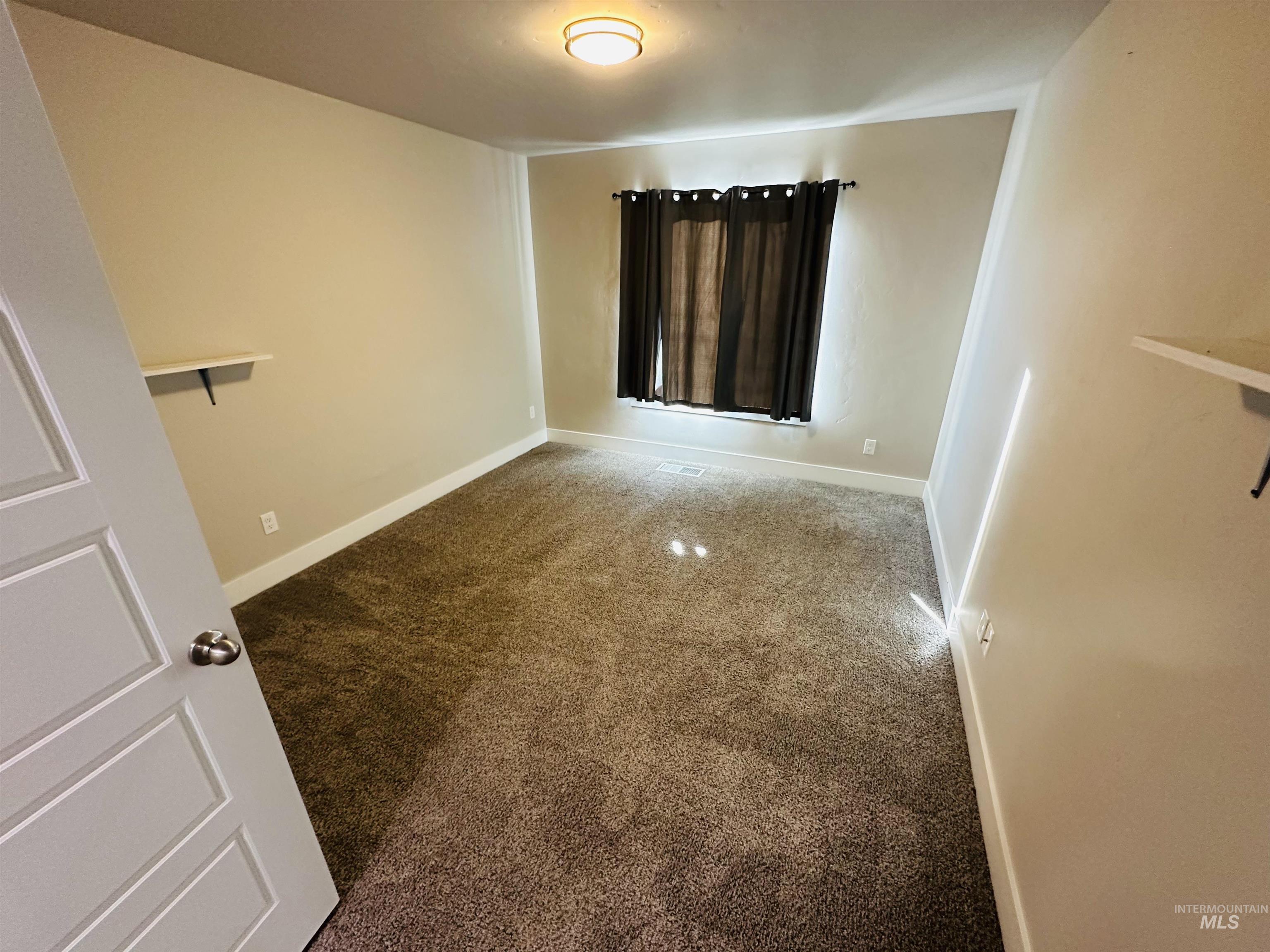 911 Campbell Street Vale, OR 97918 - Photo 20 of 37 Carpeted empty room with baseboards