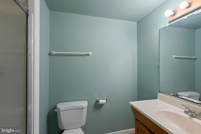 a bathroom with a sink a toilet and a light fixture