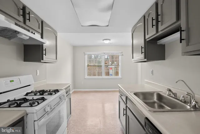 a kitchen that has a sink and a stove