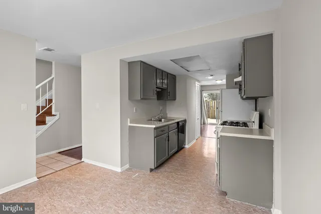 a kitchen with stainless steel appliances granite countertop a sink and a stove top oven