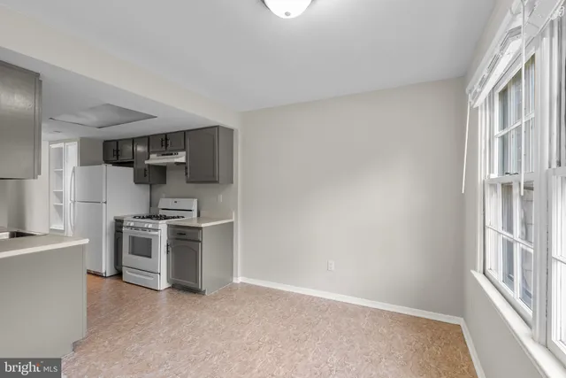 a kitchen with stainless steel appliances granite countertop a stove and a refrigerator