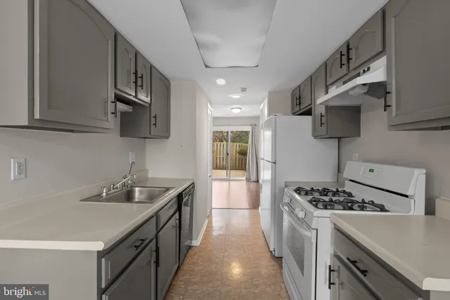 a kitchen with stainless steel appliances a sink stove and cabinets