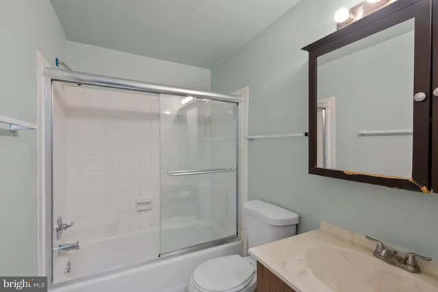 a bathroom with a shower a toilet and a sink