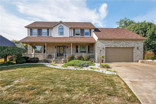 a front view of a house with garden and porch