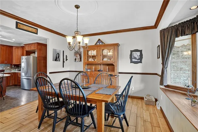a view of a dining room with furniture large window and wooden floor
