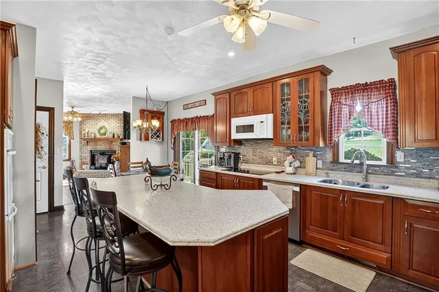 a kitchen with a table chairs sink and cabinets