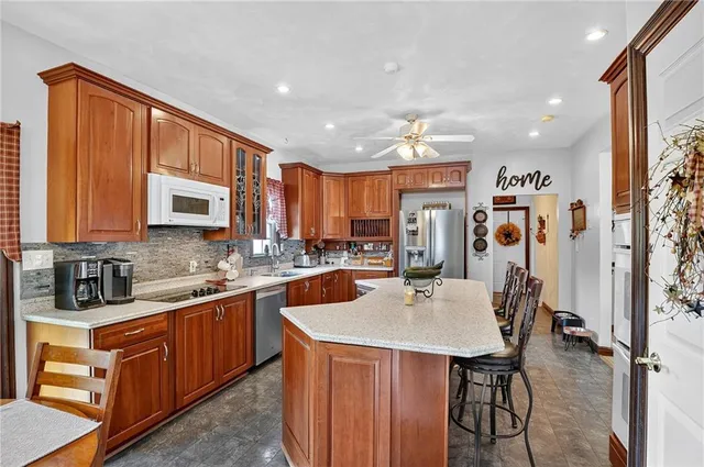 a kitchen with stainless steel appliances granite countertop a sink and cabinets