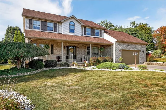 a view of a house with swimming pool and a yard