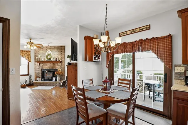 a dining room with furniture fireplace and a chandelier
