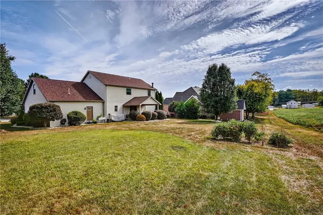 a view of a house with a yard and plants