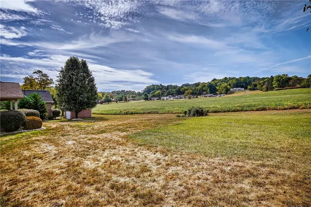 an aerial view of a house with garden space and lake view
