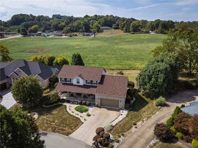 an aerial view of a houses with a swimming pool
