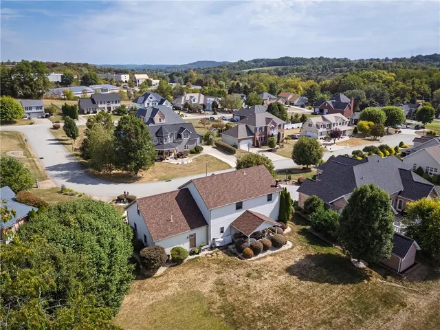 an aerial view of a houses with a lake view