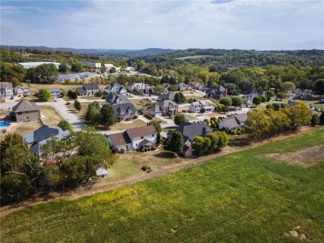 an aerial view of a house with a yard