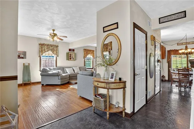 a living room with furniture a clock and a window
