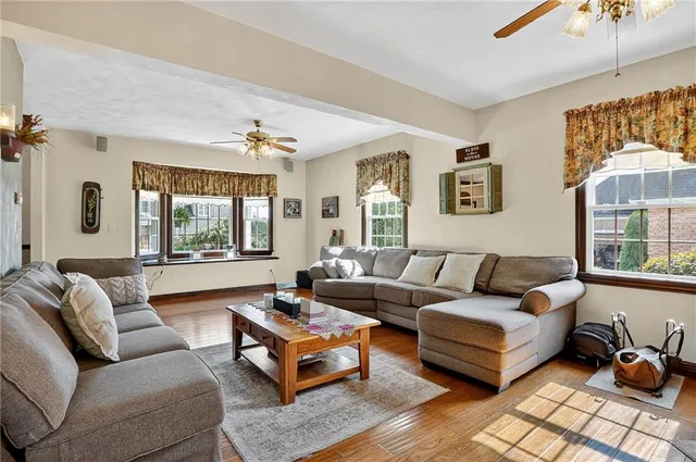a living room with furniture ceiling fan and a window