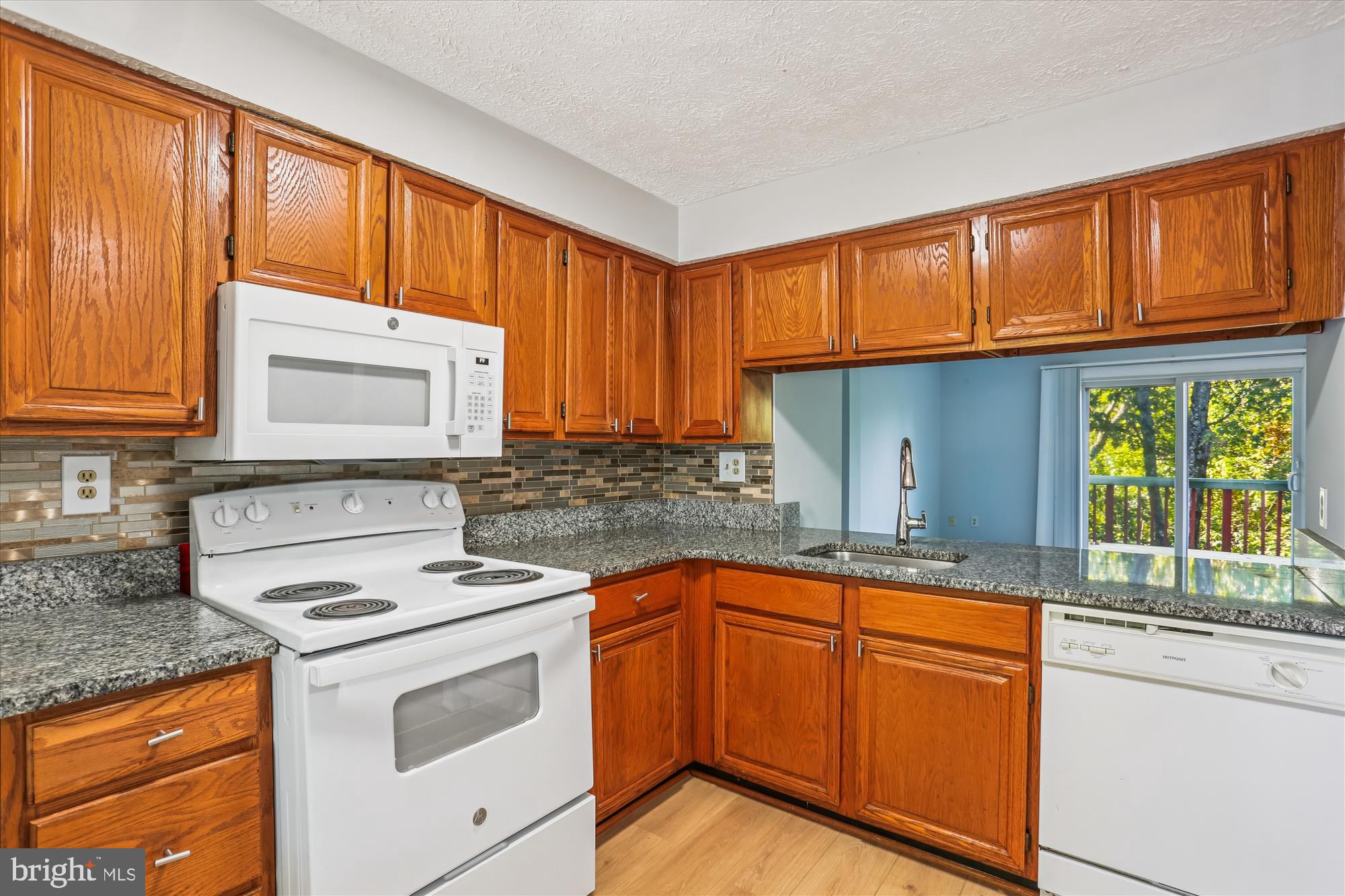 2839 Shepperton Terrace Silver Spring, MD 20904 - Photo 11 of 48 a kitchen with granite countertop cabinets stainless steel appliances a sink and window