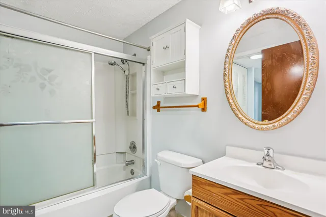 a bathroom with a sink toilet and a mirror