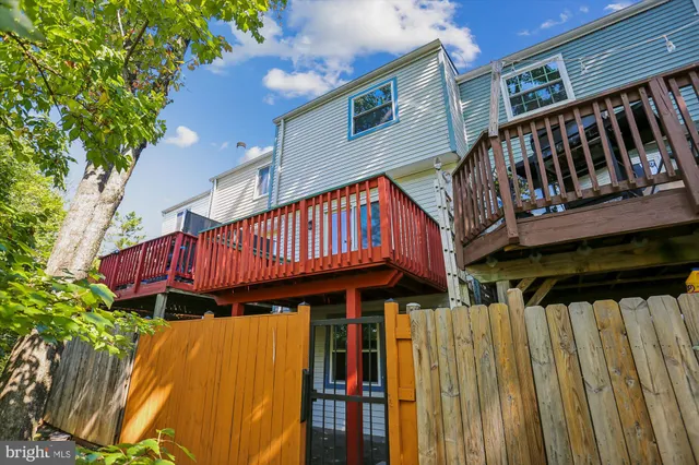 a balcony with wooden floor and fence