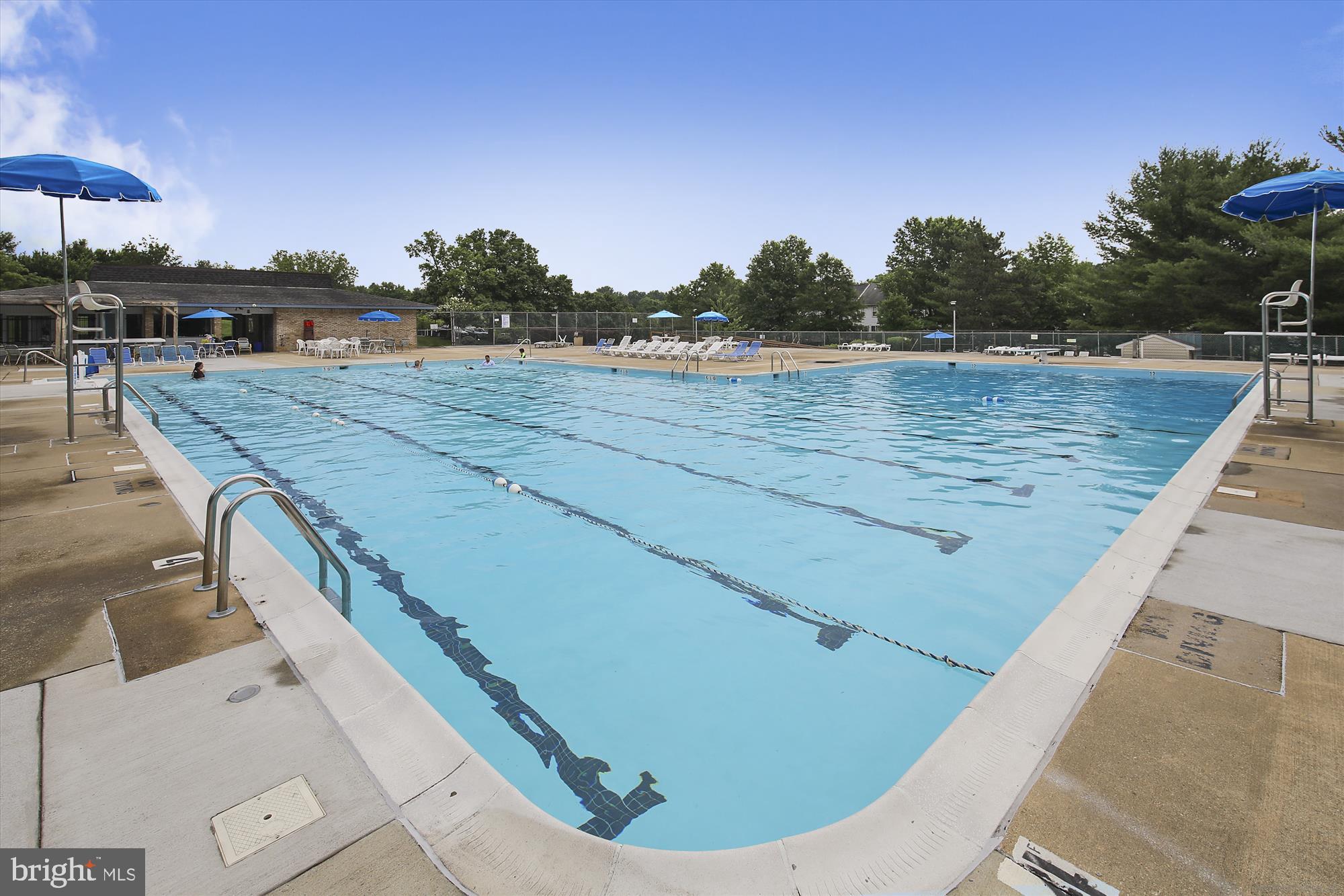 2839 Shepperton Terrace Silver Spring, MD 20904 - Photo 21 of 48 a view of a swimming pool with a lawn chairs under an umbrella