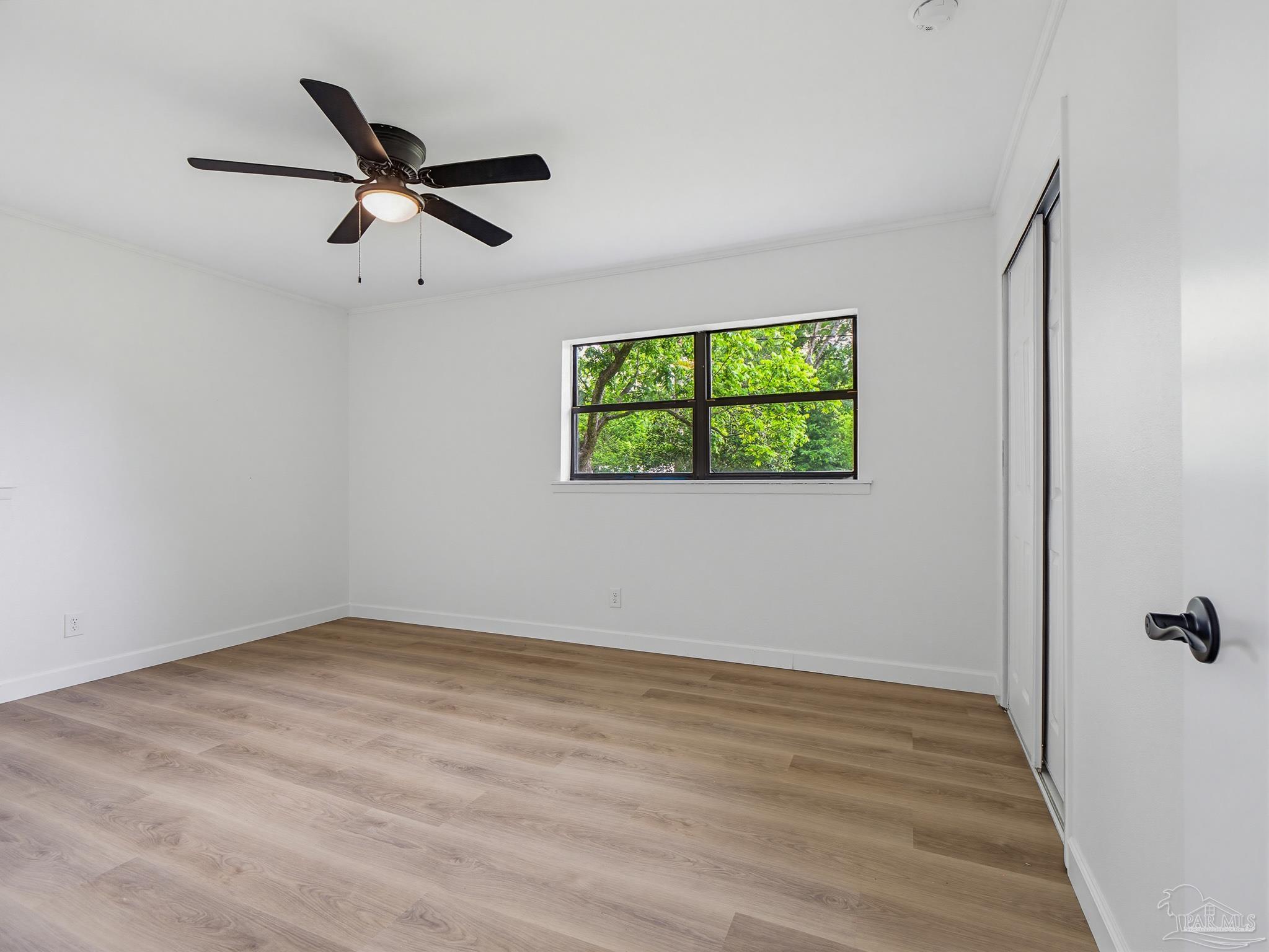 125 Madrid Road Cantonment, FL 32533 - Photo 13 of 16 a view of empty room with window and ceiling fan