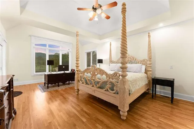 a spacious bedroom with a bed and large windows