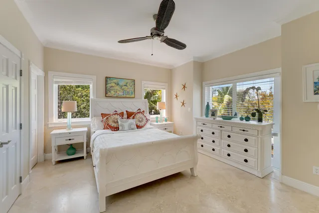 a spacious bedroom with a large bed and a chandelier