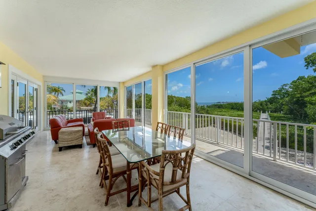 a spacious bedroom with a balcony a bed and a walk in closet with wooden floor