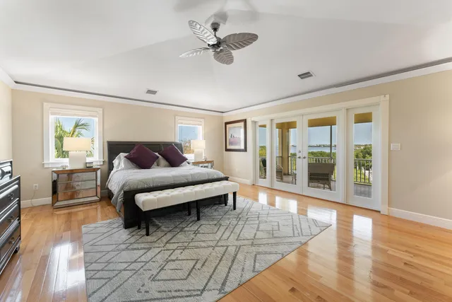 a view of a big room with wooden floor and windows
