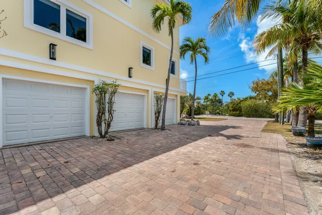 a view of a house with a yard and a garage