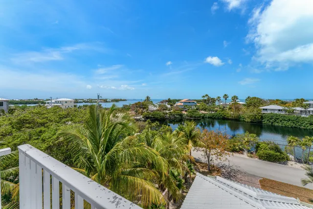 a view of a lake with houses in the back