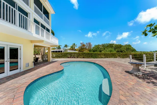 an aerial view of residential houses with outdoor space and river