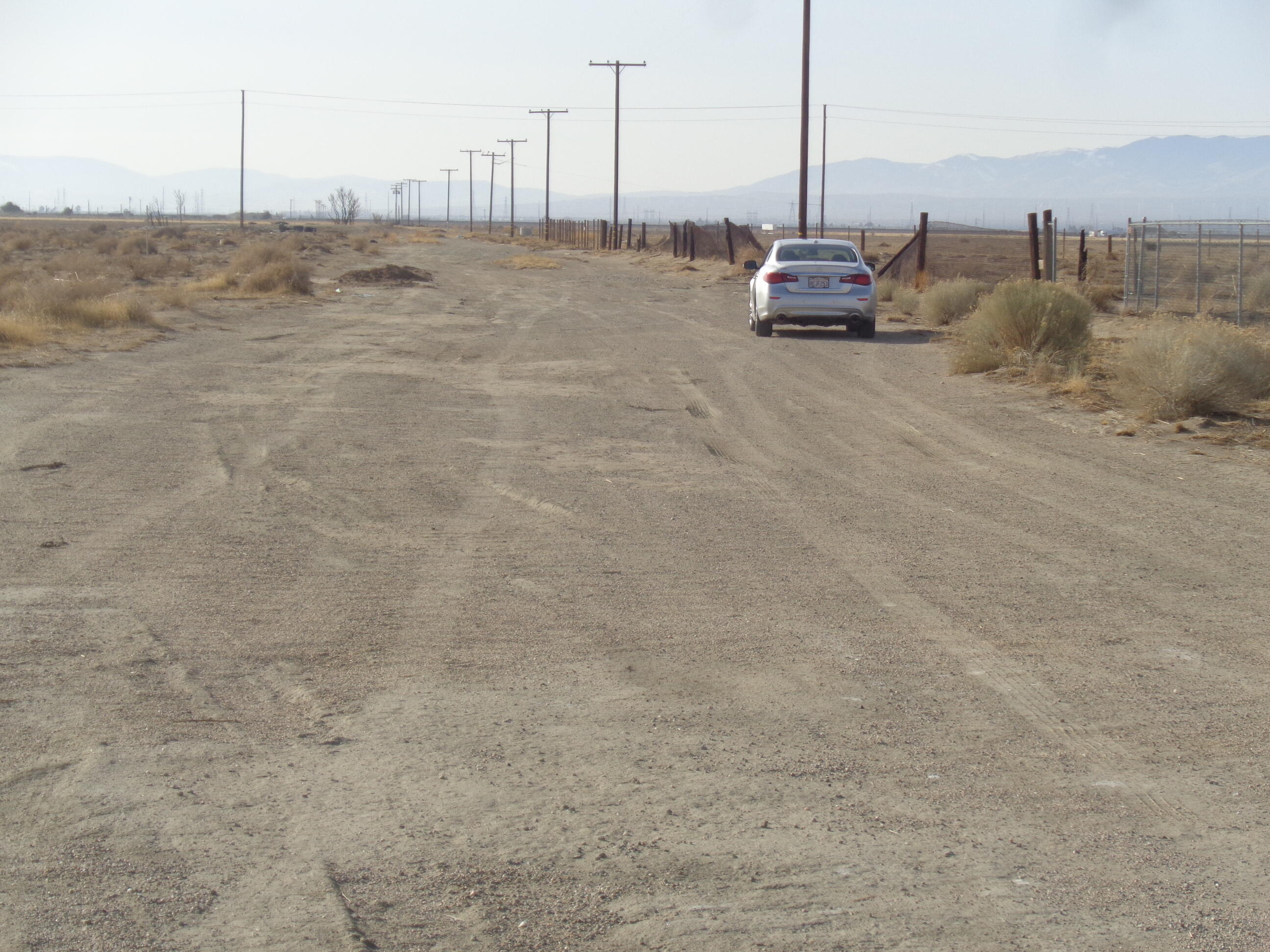 2011 67th Street West Rosamond, CA 93560 - Photo 14 of 21 a car parked in the middle of a field