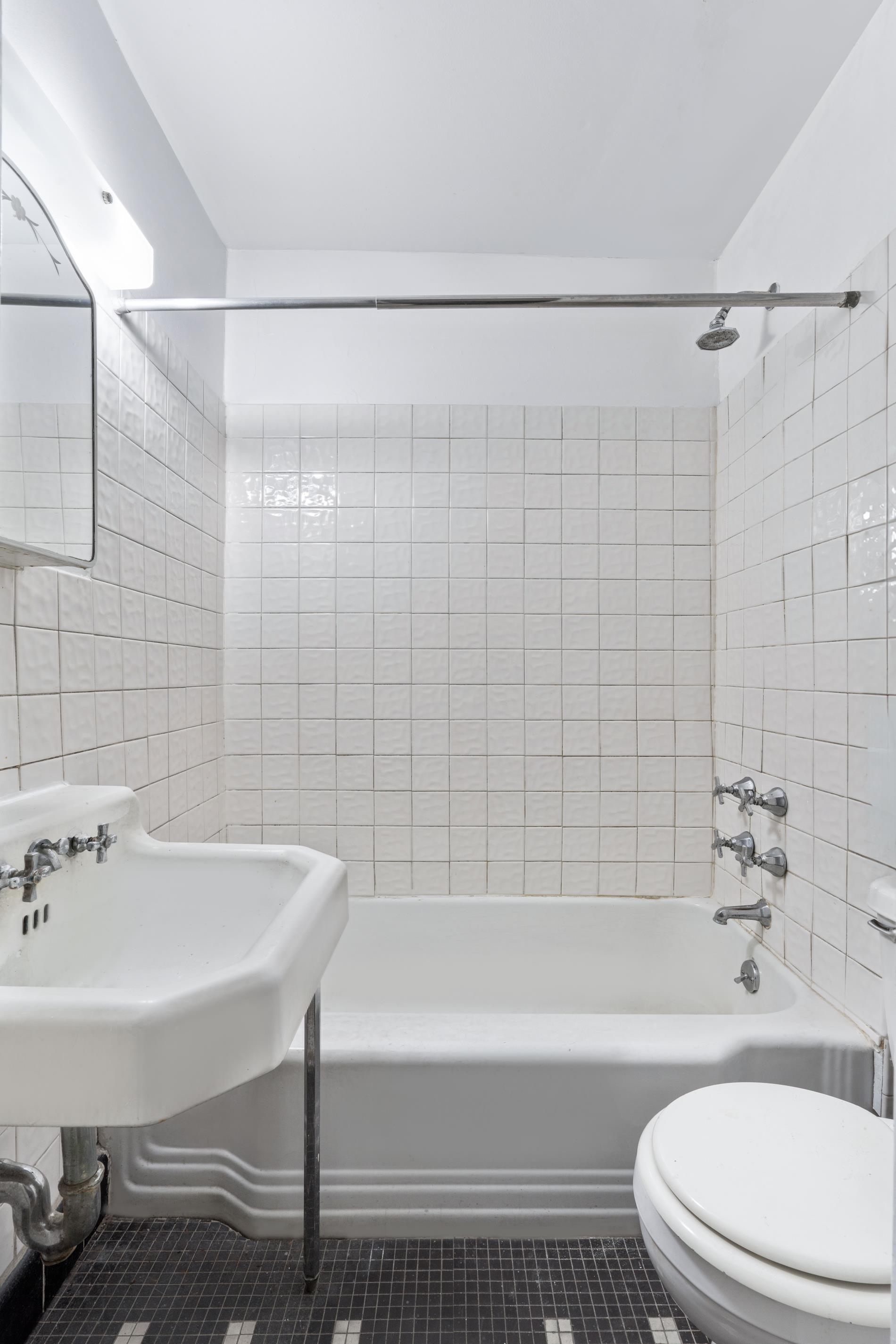 142 East 37th Street, Unit 23 Manhattan, NY 10016 - Photo 9 of 15 a bathroom with a sink a toilet and shower