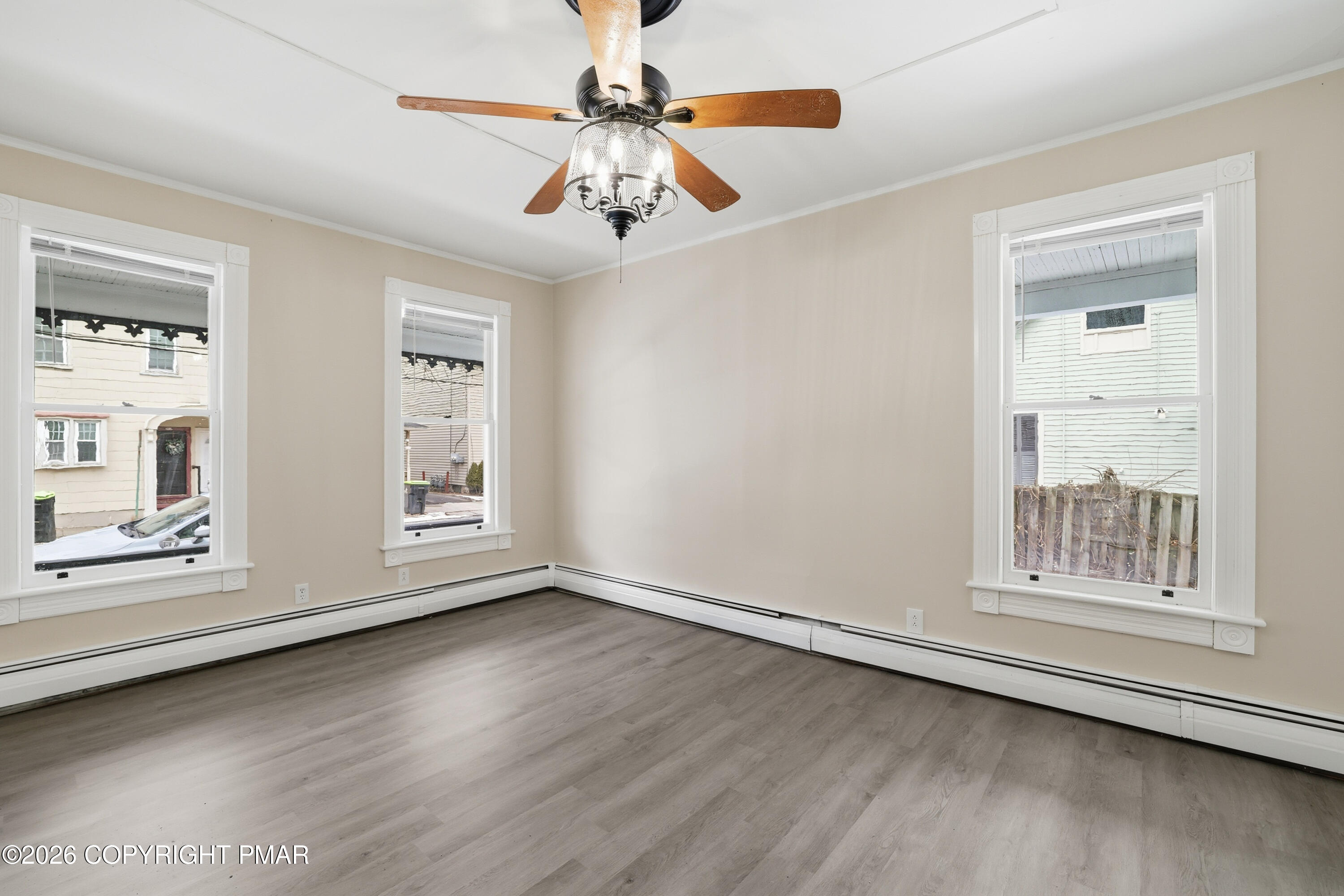 809 Monroe Street Stroudsburg, PA 18360 - Photo 11 of 55 an empty room with wooden floor fan and windows