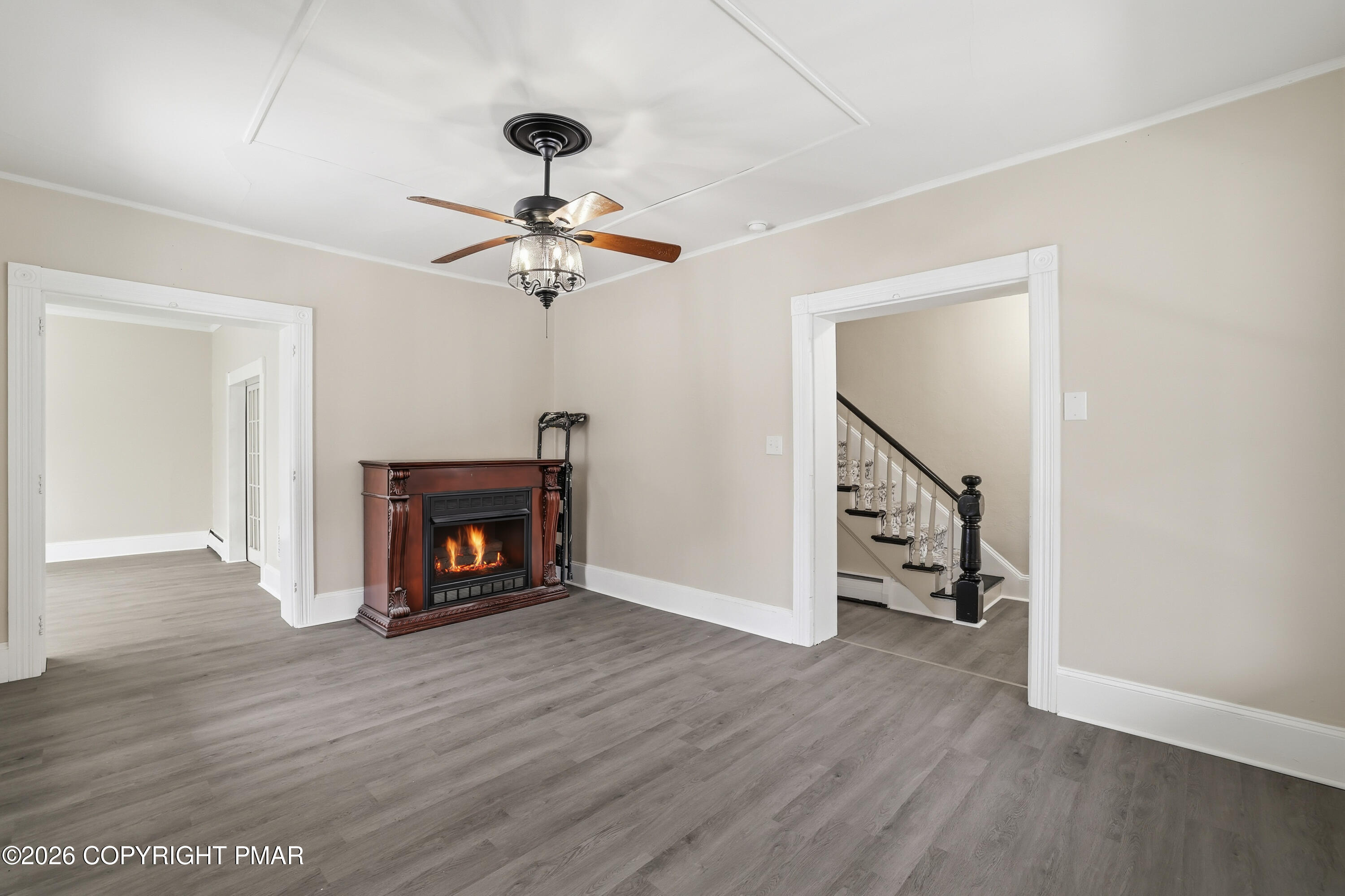 809 Monroe Street Stroudsburg, PA 18360 - Photo 12 of 55 a view of a livingroom with a fireplace a ceiling fan and wooden floor