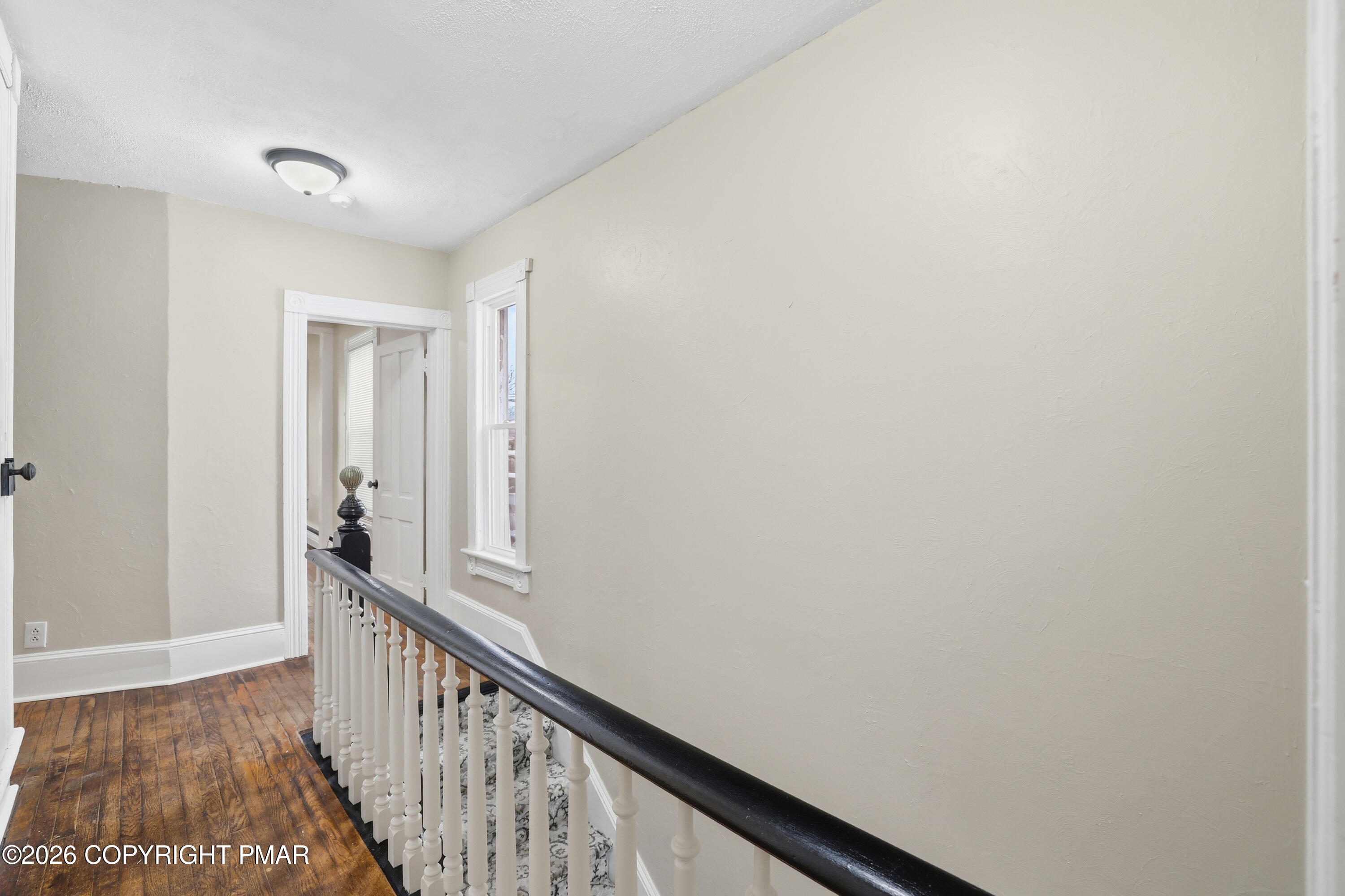809 Monroe Street Stroudsburg, PA 18360 - Photo 24 of 55 a view of a hallway with wooden floor and a bathroom