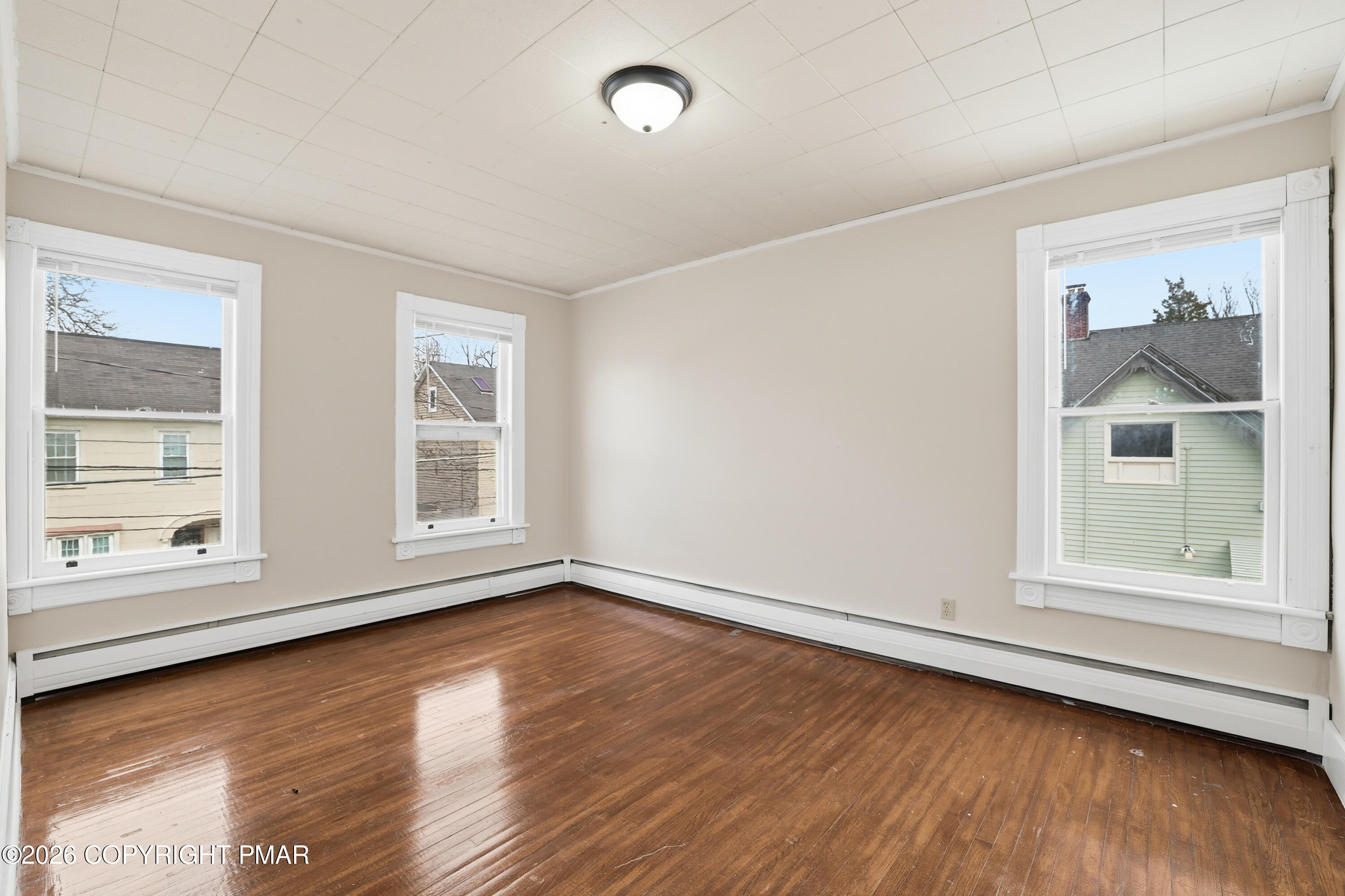 809 Monroe Street Stroudsburg, PA 18360 - Photo 26 of 55 an empty room with wooden floor and windows