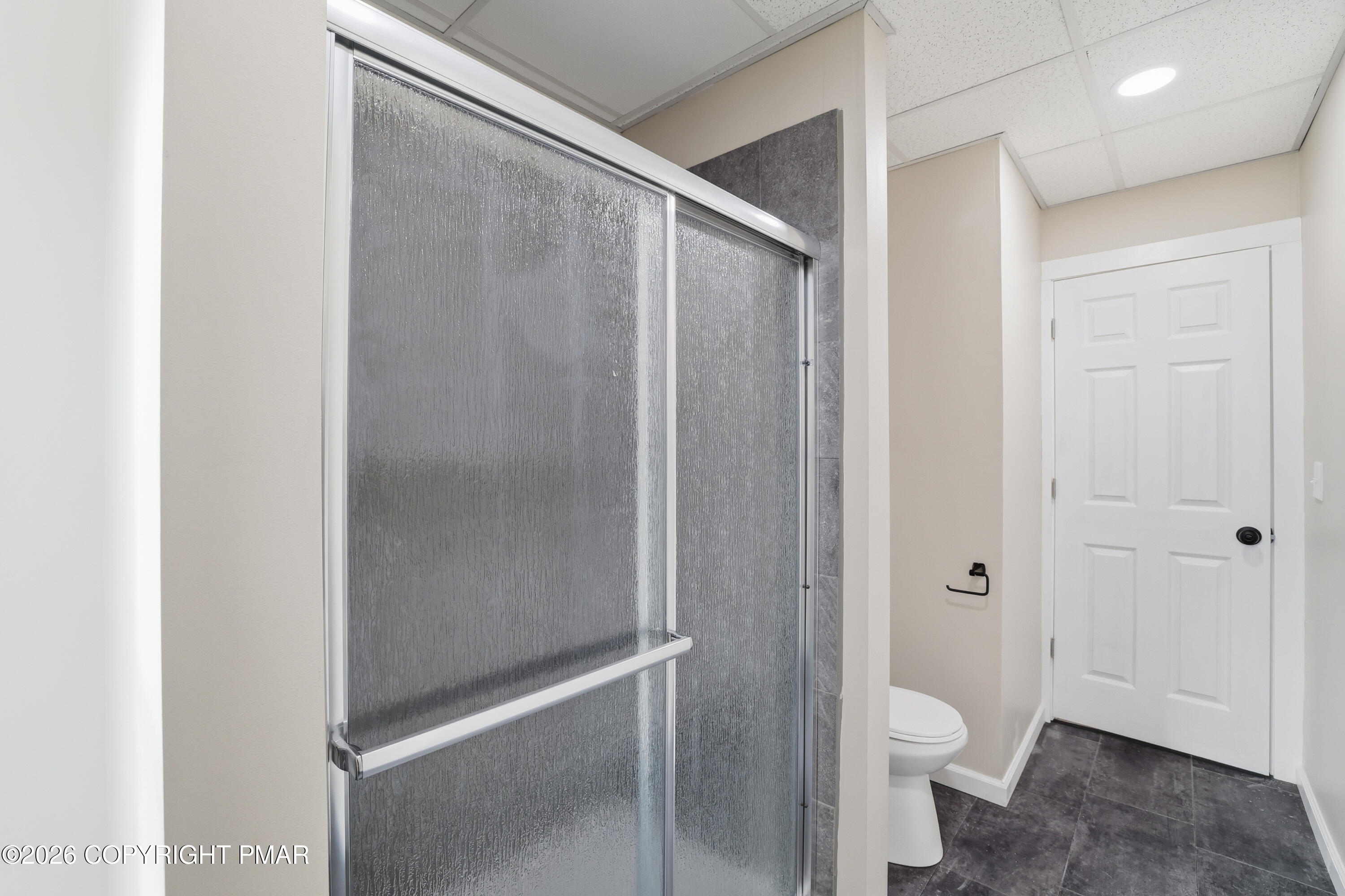 809 Monroe Street Stroudsburg, PA 18360 - Photo 35 of 55 a bathroom with a granite countertop toilet and a shower