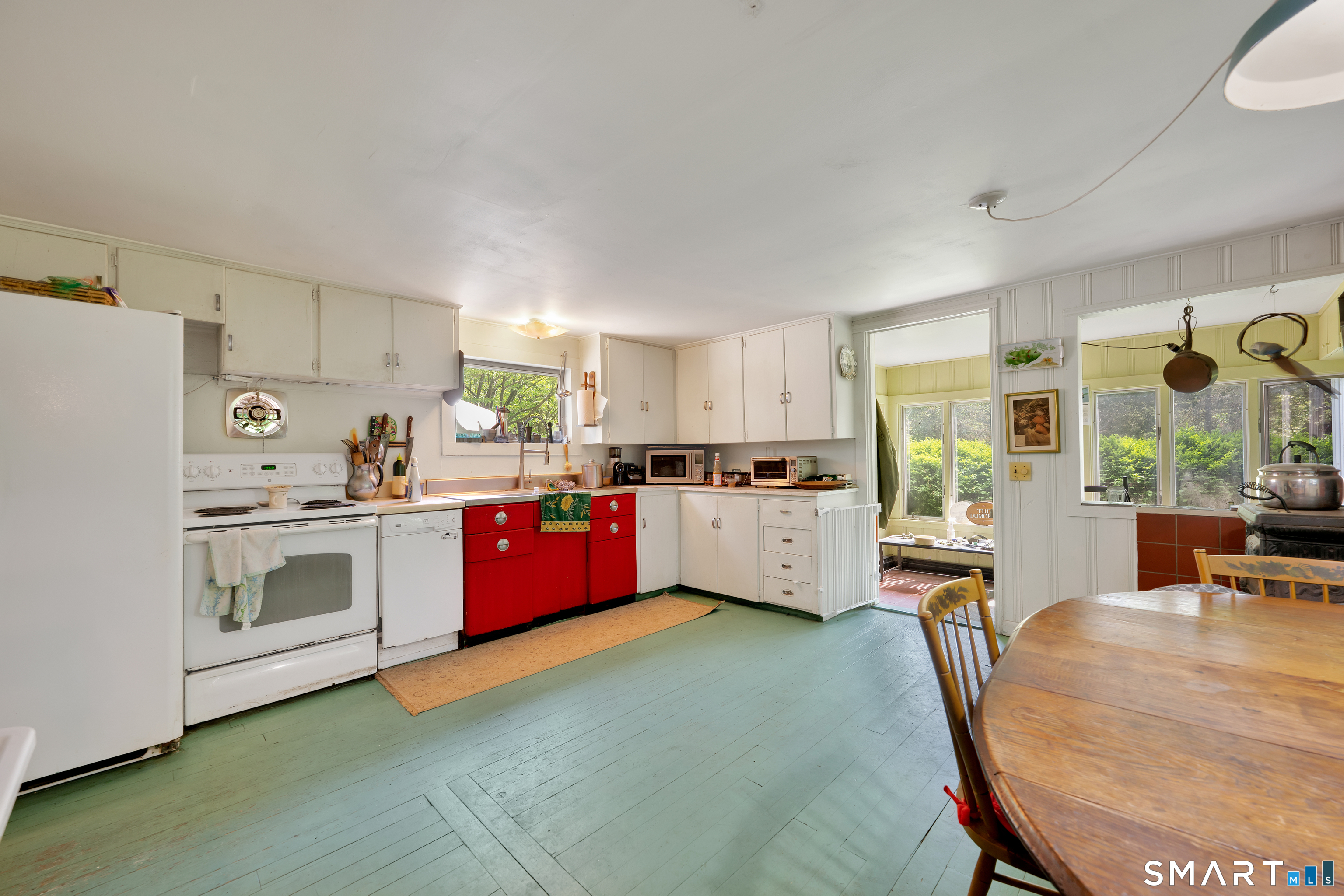 231 B Kent Road Kent, CT 06757 - Photo 7 of 35 a kitchen with stainless steel appliances kitchen island granite countertop a stove a sink a refrigerator white cabinets and wooden floor