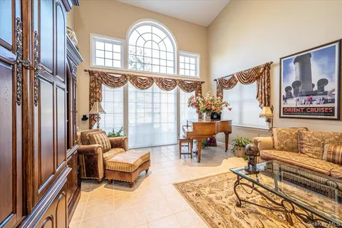 a living room with lots of furniture and a chandelier
