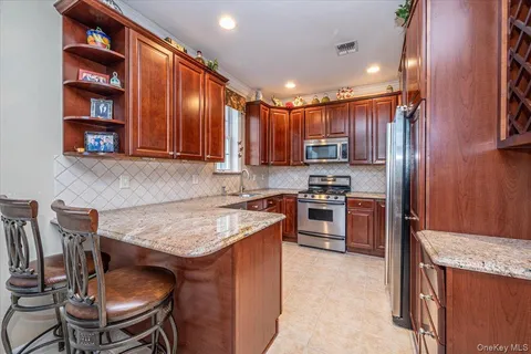 a kitchen with wooden cabinets and stainless steel appliances