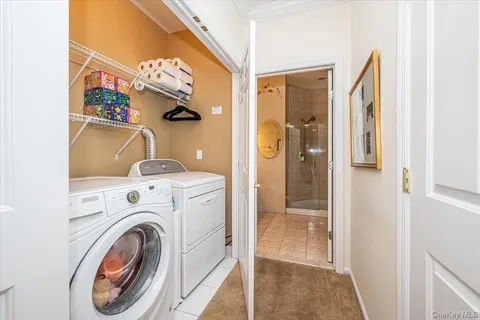 a bathroom with a double vanity sink mirror and shower