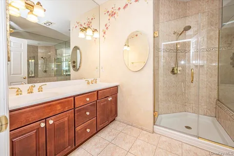 a spacious bathroom with a tub sink shower and mirror