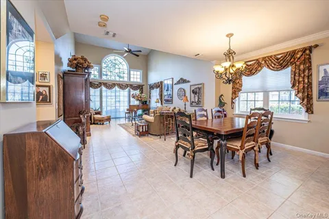 a view of a dining room with furniture and chandelier